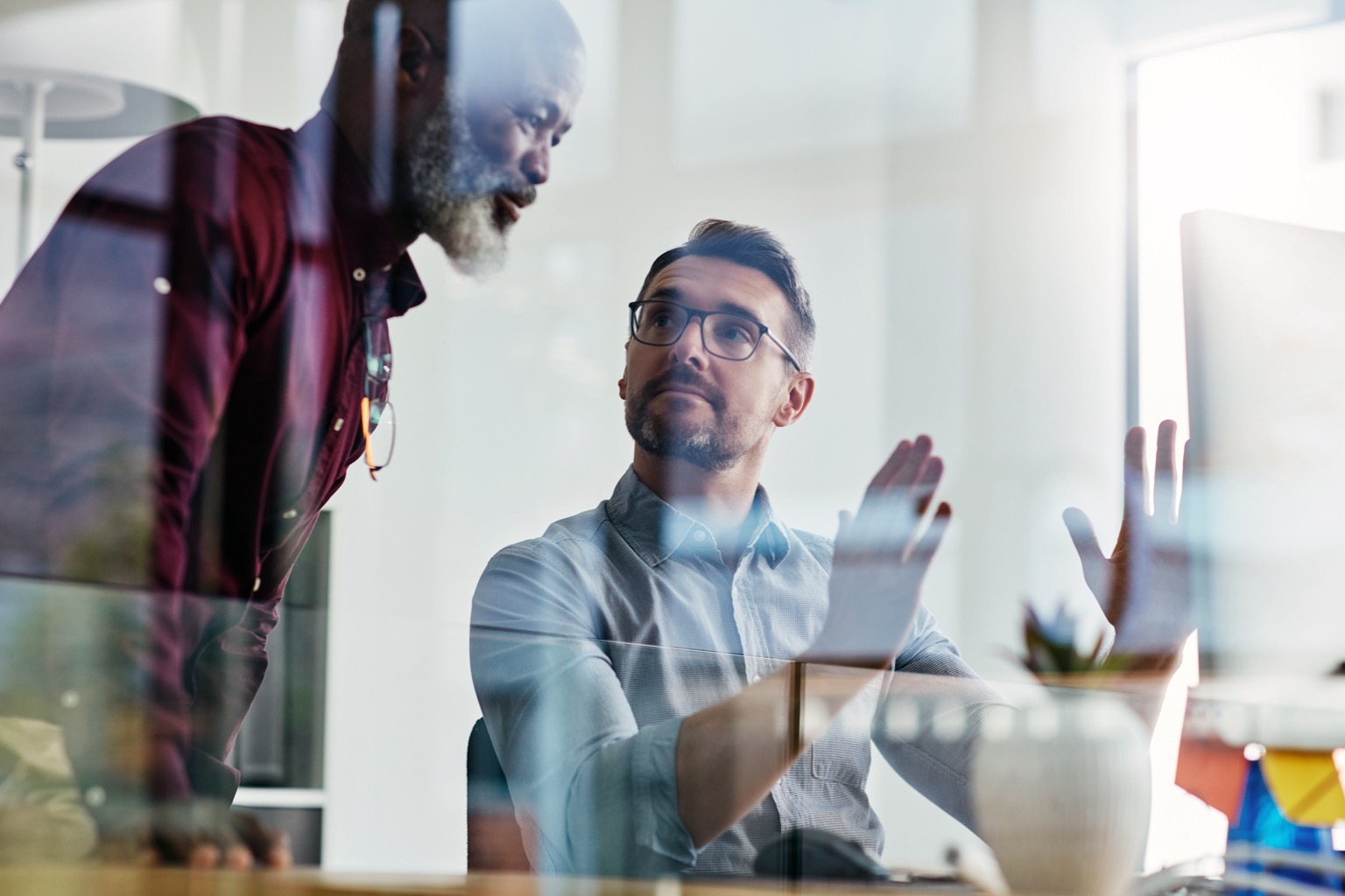 Business colleagues collaborating over a screen