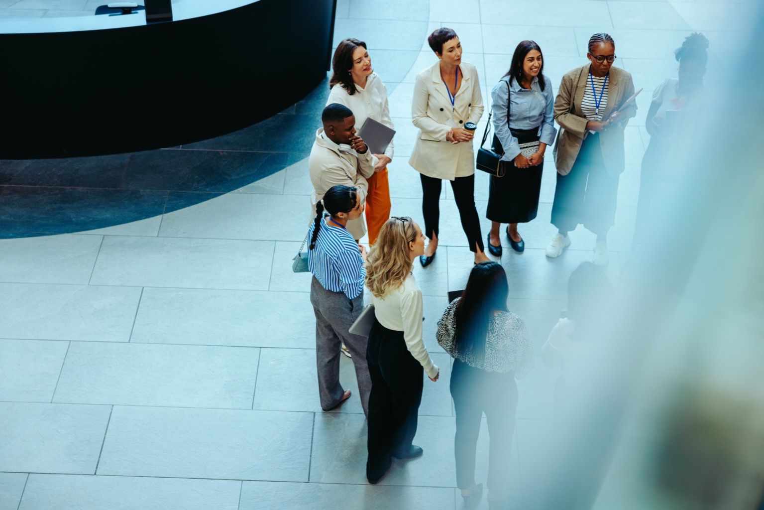 A diverse team of colleagues gathered in a corporate lobby