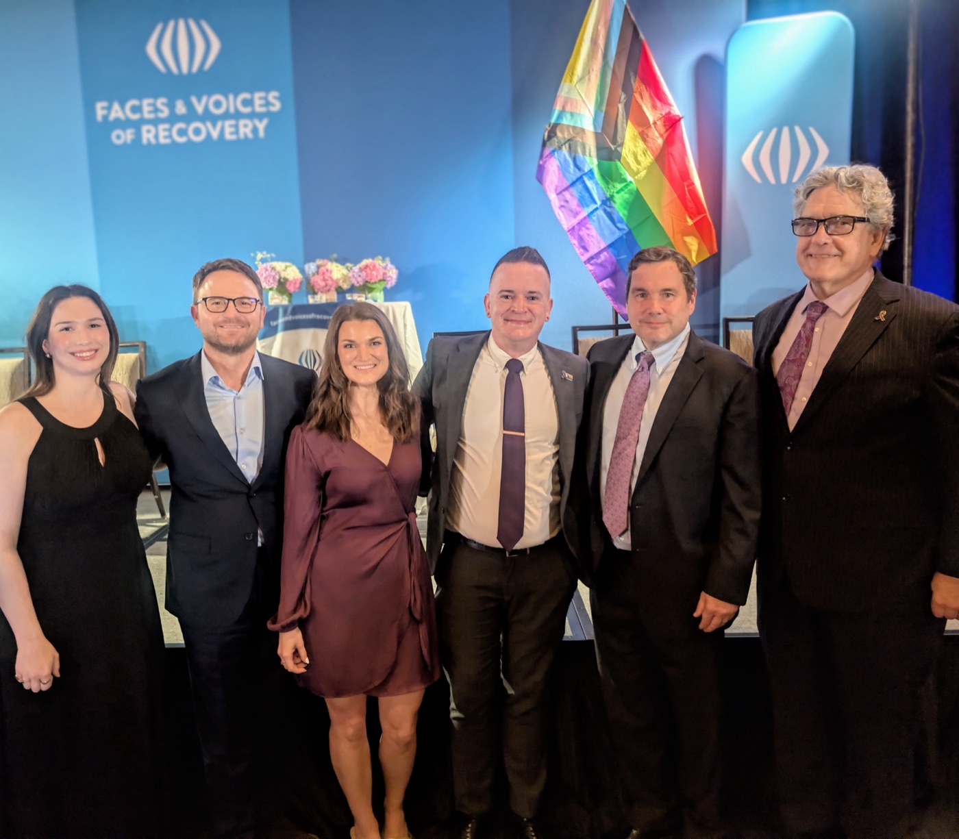 A group celebrating together at a Faces and Voices of Recovery event